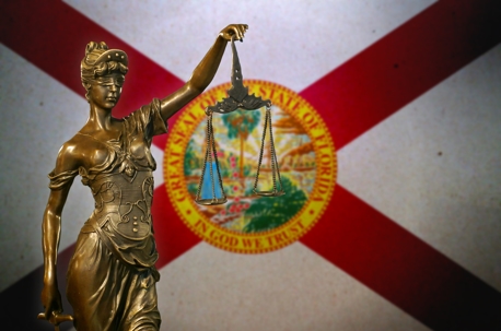 Lady Justice before a flag of Florida